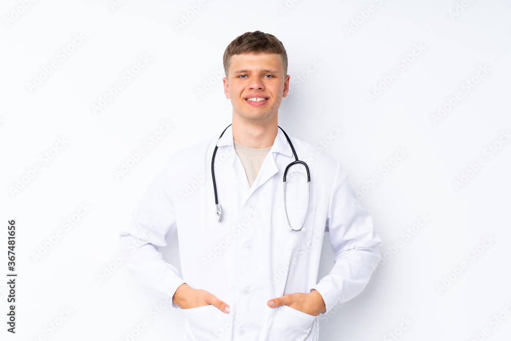 Young handsome man over isolated white background with doctor gown Young handsome man over isolated white background with doctor gown