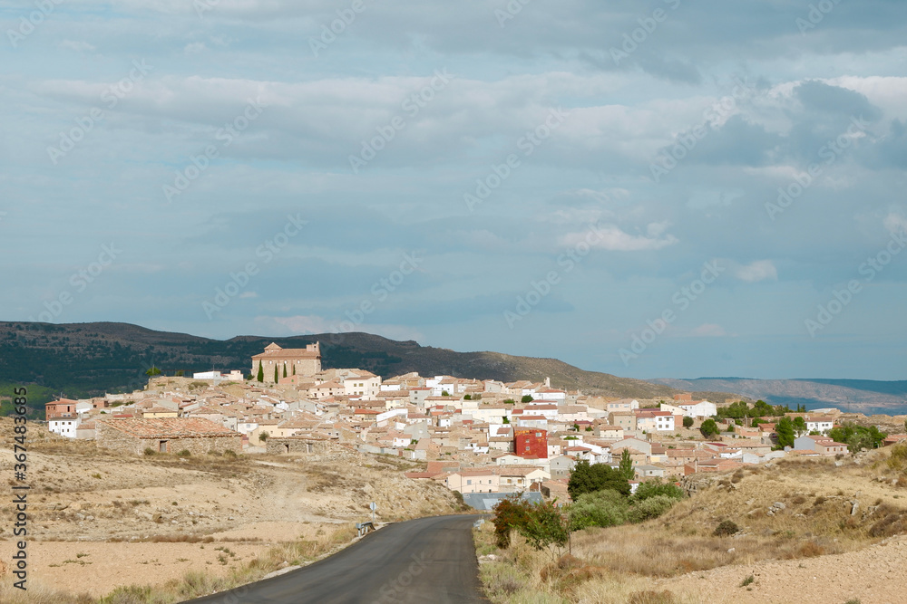 Asphalt country road leading to Alacon village, deserted land of Teruel, Aragon, Spain.