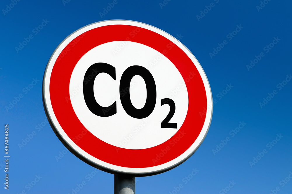A red circle traffic sign demanding the CO2 carbon dioxide emmisions from industry to stop rising and save environment A red circle traffic sign demanding the CO2 carbon dioxide emmisions from industry to stop rising and save environment