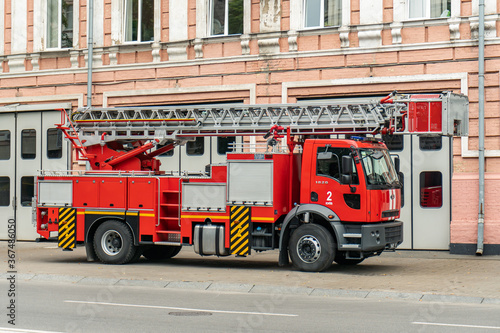 Kyiv (Kiev), Ukraine - July 26, 2020: A big red fire-fighting vehicle (forcing-engine) near a fire station