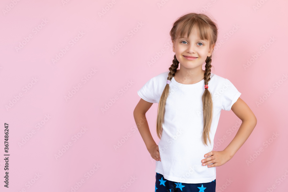 Beautiful little blonde girl with long hair in white T-shirt smiling on a pink background Beautiful little blonde girl with long hair in white T-shirt smiling on a pink background