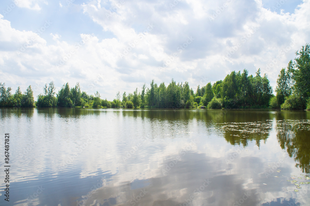 Fototapeta premium Summer lake shore with sky reflection