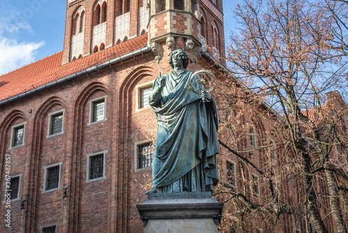 Statue of Nicolaus Copernicus and Old Town City Hall on the main square of historic part of Torun city in north central Poland