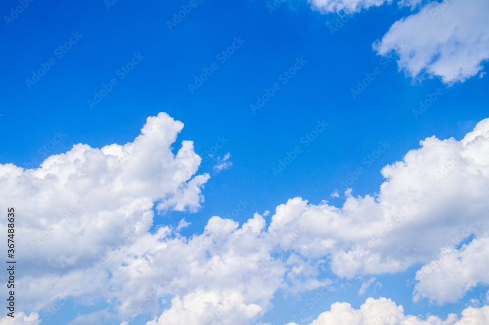 White bright contrasting clouds on blue sky