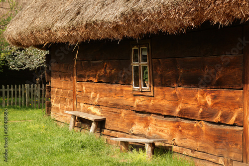 An image of an old village with a house and a bench. photo