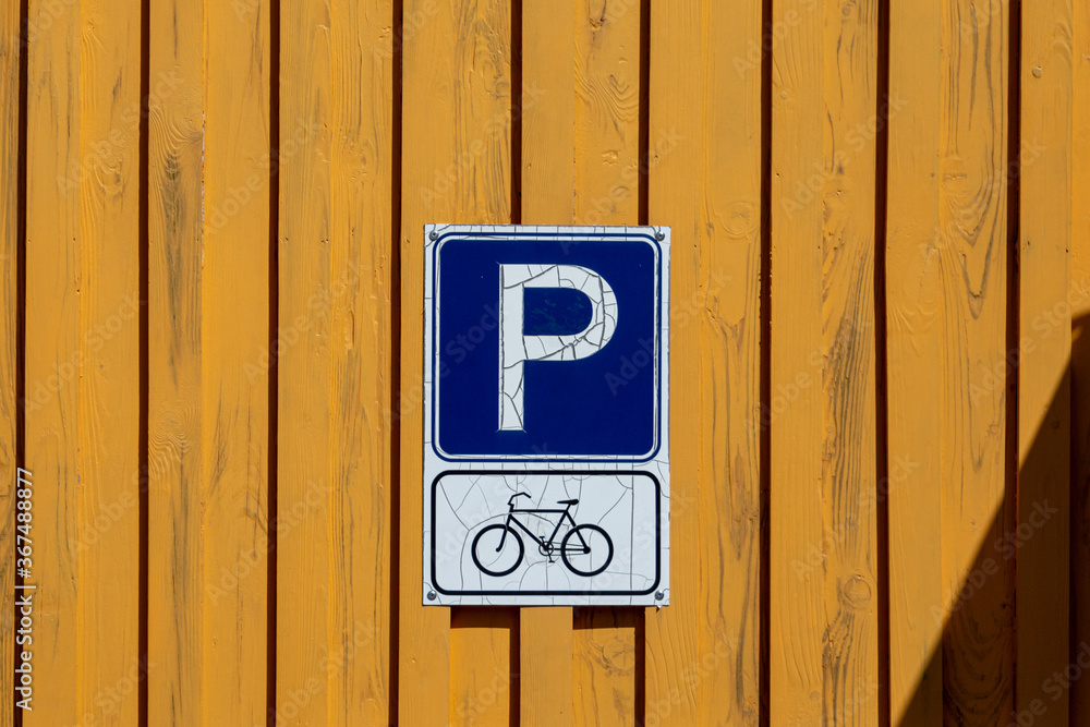 Bicycle parking sign. Bicycles in the city. Wooden board wall. Bicycle parking sign. Bicycles in the city. Wooden board wall.