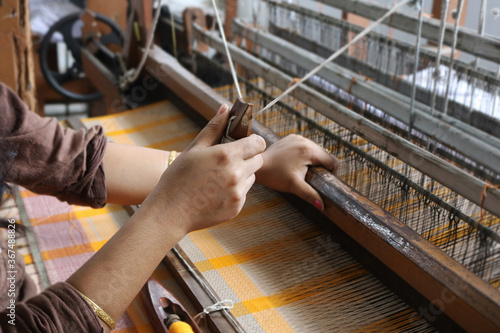 Handloom weaver in India working in her loom