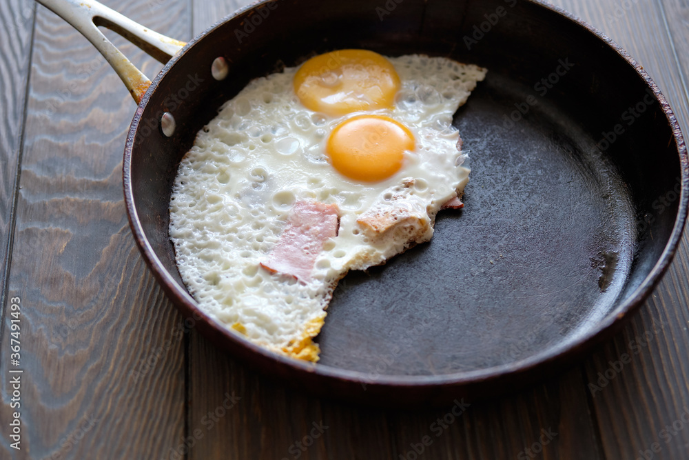 Fried egg with fried egg on a cooking pan Fried egg with fried egg on a cooking pan