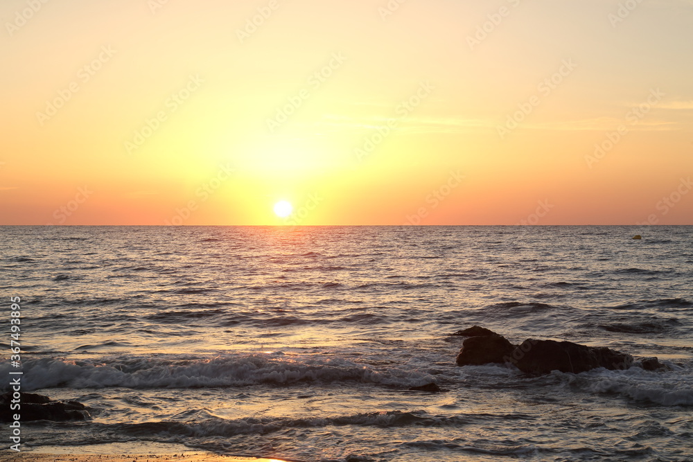Sunrise on the beach by the Mediterranean Sea