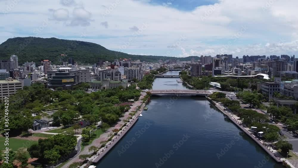 flying backwards over the love river in Kaohsiung, Taiwan on a sunny day with a few clouds flying backwards over the love river in Kaohsiung, Taiwan on a sunny day with a few clouds