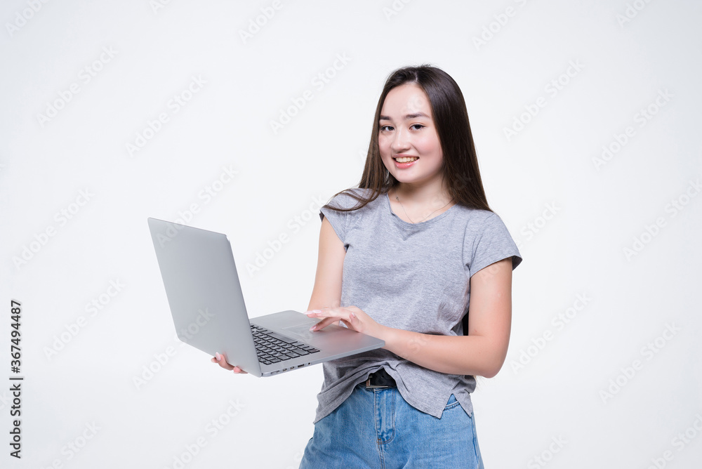 Attractive smiling young woman holding laptop computer isolated on white background Attractive smiling young woman holding laptop computer isolated on white background