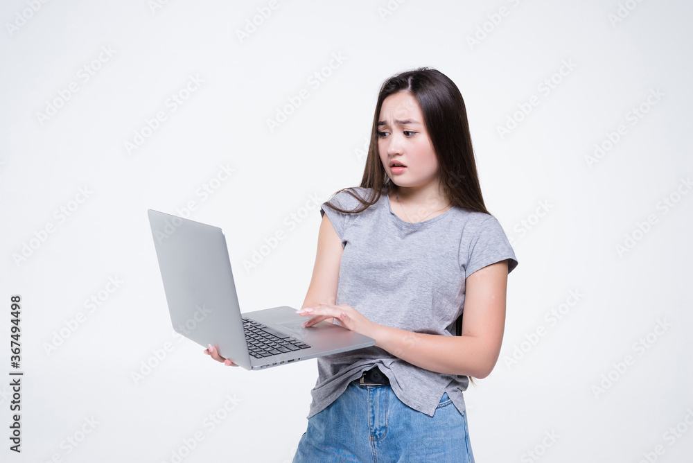 Attractive smiling young woman holding laptop computer isolated on white background Attractive smiling young woman holding laptop computer isolated on white background