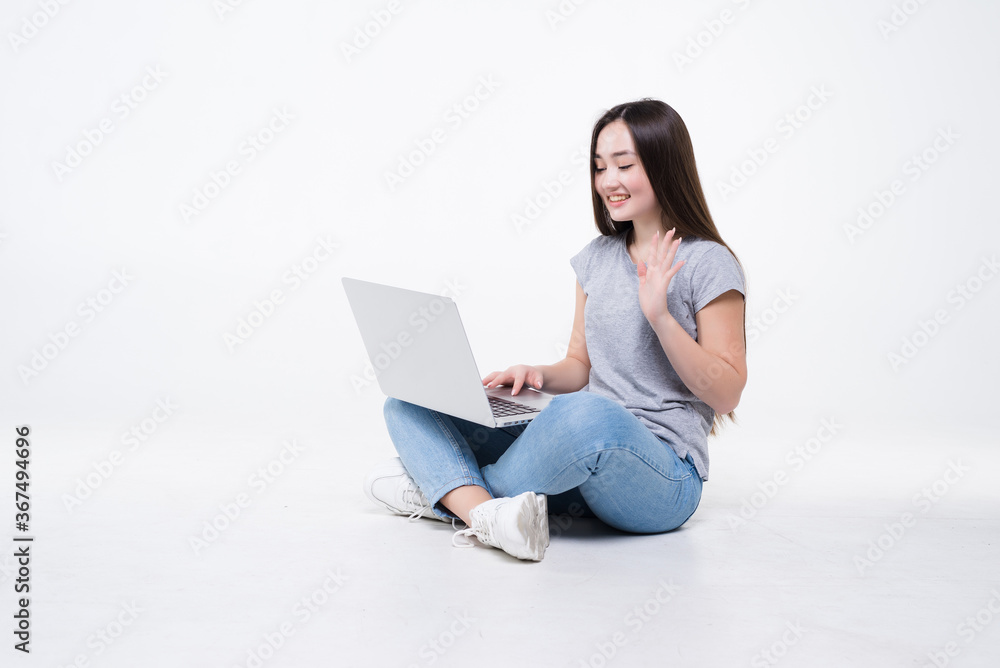 Sociable asian girl taking selfie or speaking on video call using cell phone isolated over white background Sociable asian girl taking selfie or speaking on video call using cell phone isolated over white background