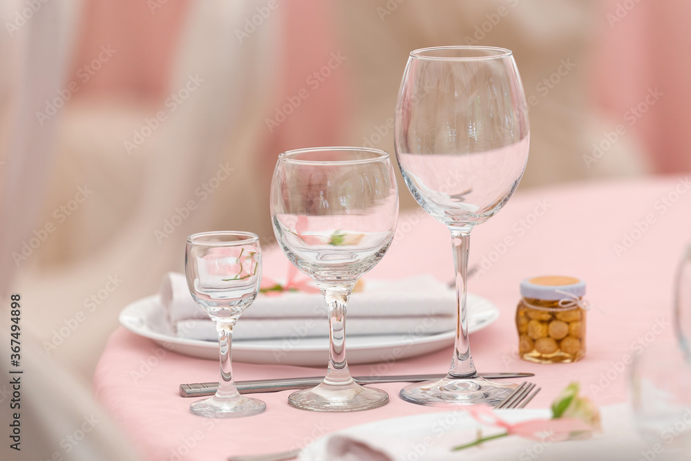 Beautiful decoration set for wedding party. Design by flower, variety luxury glass and candle. Selective focus Beautiful decoration set for wedding party. Design by flower, variety luxury glass and candle. Selective focus