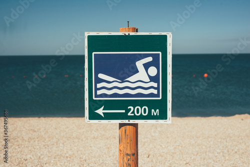 Swimming place sign on the с. Buoys for swimming in the sea. Swimming area. Permissive sign. Sign place for swimming.