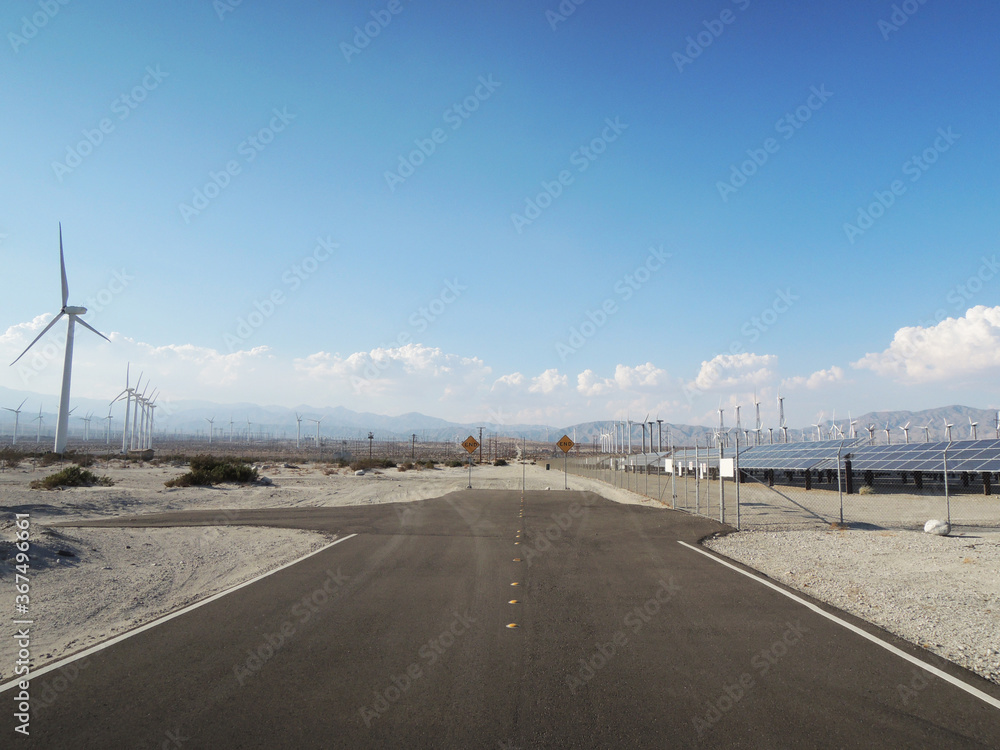 Naklejka premium End of the road with a view of wind turbines in the wilderness