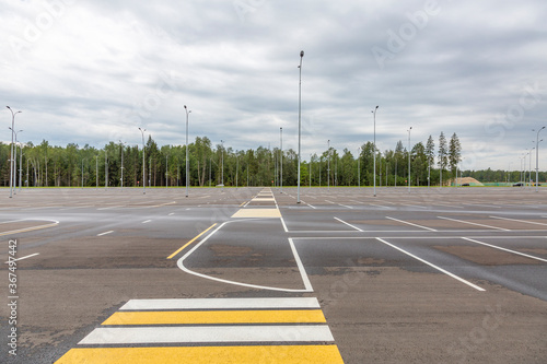 Empty free outdoor parking near the shopping mall on a cloudy summer day