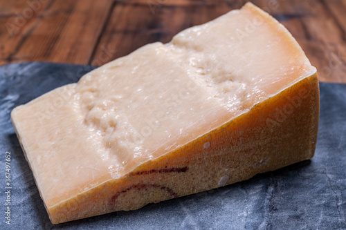 Big wedge of parmigiano-reggiano parmesan hard Italian cheese made from cow milk or Grana Padano