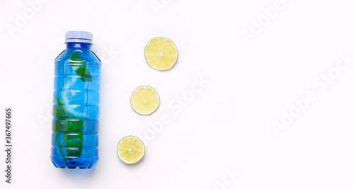 Isotonic sports drink in a blue bottle on a white background. Copy space