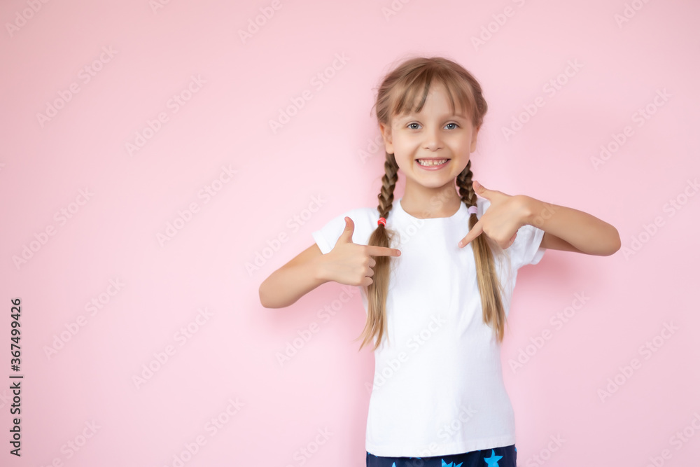 t-shirt design concept - smiling little girl in blank white t-shirt pointing at herself t-shirt design concept - smiling little girl in blank white t-shirt pointing at herself