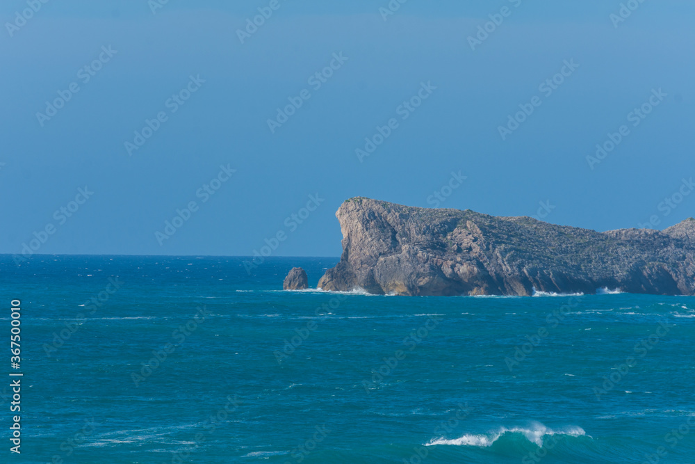 Cliff view with sky and blue sea, a summer afternoon, in Liencres, Cantabria, Spain, horizontal