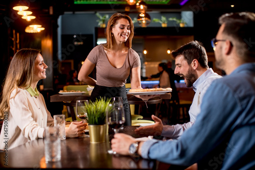 Waiter woman serving group ...