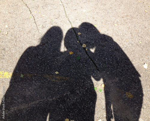 three person shadows discuss some secret 