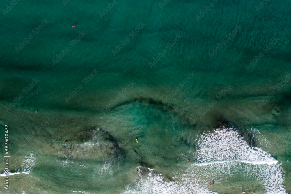 Obraz premium Beach, beautiful waves, blue water at sunrise. Top view from drone.