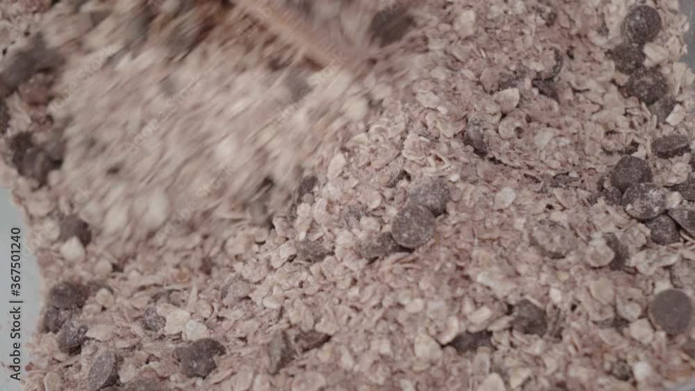 Closeup, Mixing dry ingredients of chocolate chip oatmeal raisin cookies Closeup, Mixing dry ingredients of chocolate chip oatmeal raisin cookies