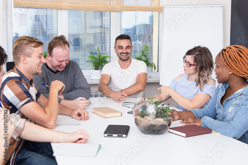 Group of happy multiracial people in a meeting room studying or working together. Advanced training, education in the company