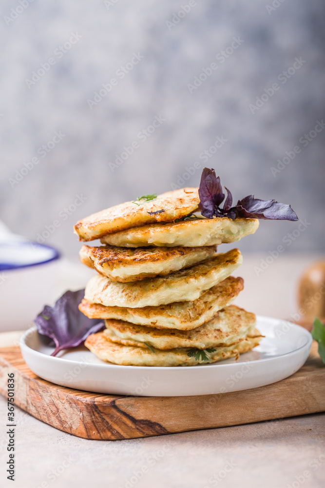 Vegetarian zucchini fritters or pancakes stack topped with sour cream and cilantro. Vegetable pancakes Vegetarian zucchini fritters or pancakes stack topped with sour cream and cilantro. Vegetable pancakes