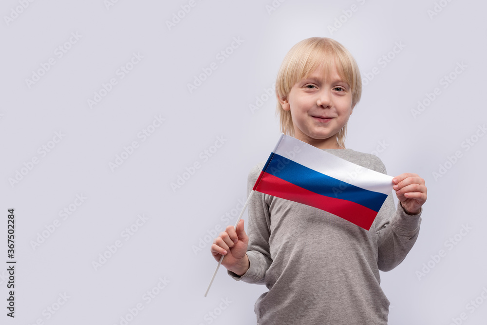 Smiling child holds a Russian flag. Learning Russian for kids. Copy space Smiling child holds a Russian flag. Learning Russian for kids. Copy space
