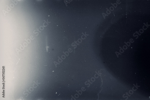 Фотография Grainy toned film frame with scratches, dust and grain