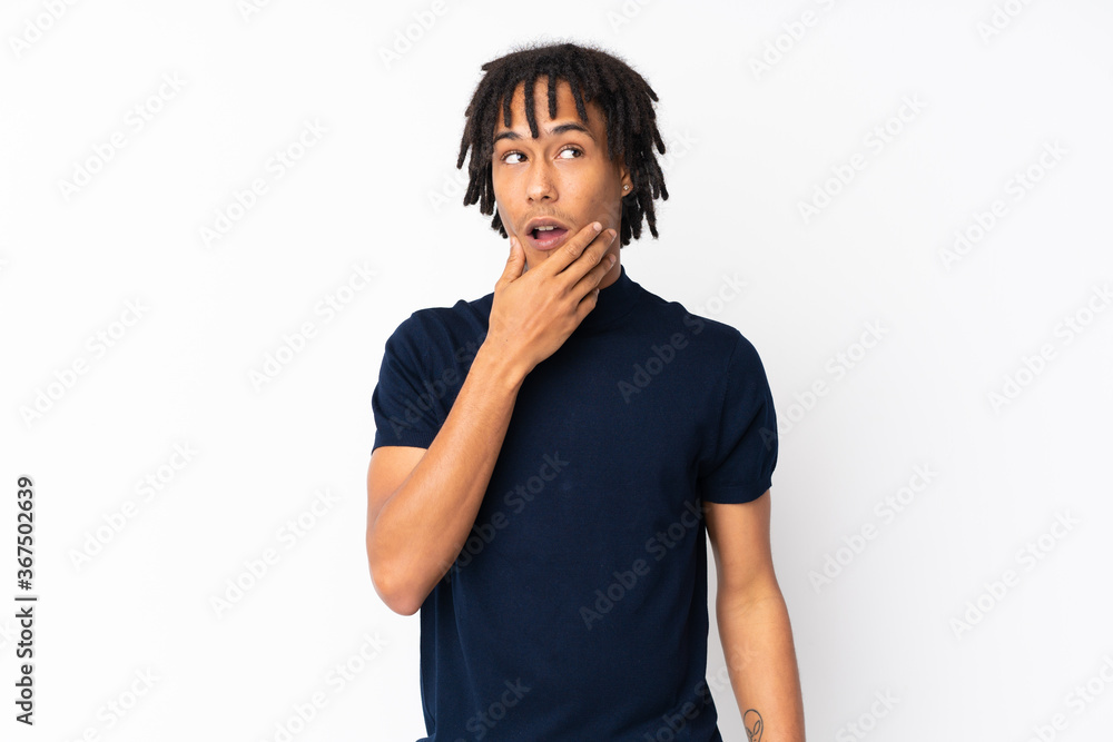 Young african american man isolated on white background surprised and shocked while looking right Young african american man isolated on white background surprised and shocked while looking right