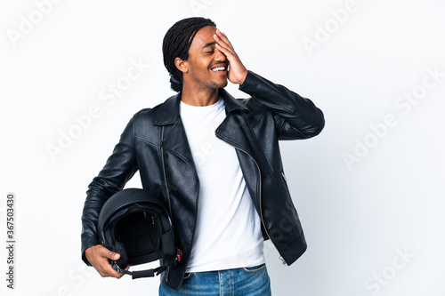 African American man with braids holding a motorcycle helmet isolated on white background smiling a lot