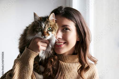 Canvastavla Charismatic young woman playing with her adorable cat.