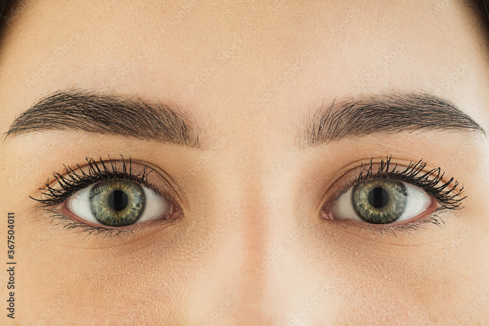 Obraz premium Close up of face, eyes of beautiful caucasian young woman, clear look. Human emotions, facial expression, cosmetology, body and skin care concept. Hopeful, dreamful look, sight. Psychology, fashion.