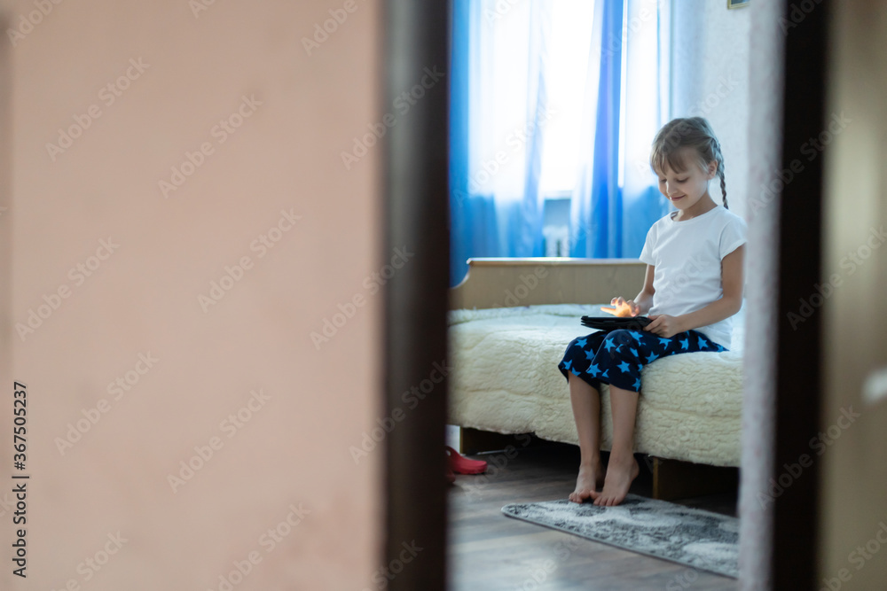 Remote lessons. The child smiles happily and gets knowledge remotely. Little girl study online learning from home with laptop. Online school. Remote lessons. The child smiles happily and gets knowledge remotely. Little girl study online learning from home with laptop. Online school.