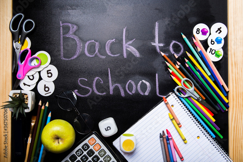 style school elements - book, pen, pencils,  apple on blackboard. Back to school design template.