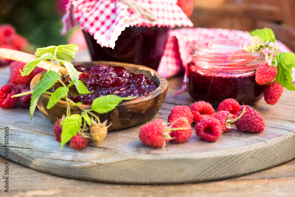 Fresh raspberries jam with fresh raspberries on natural garden. Selective focus Fresh raspberries jam with fresh raspberries on natural garden. Selective focus