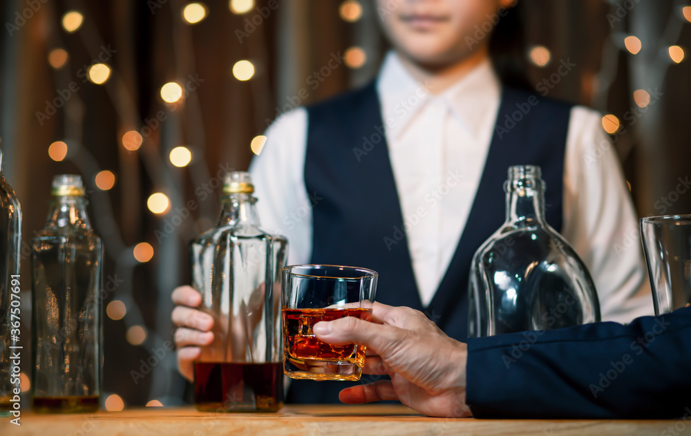 Bartender Serve Whiskey on wood bar