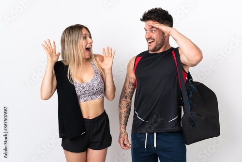 Young sport couple isolated on white background with surprise and shocked facial expression