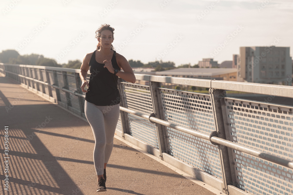 Young woman running at the Bridge	
