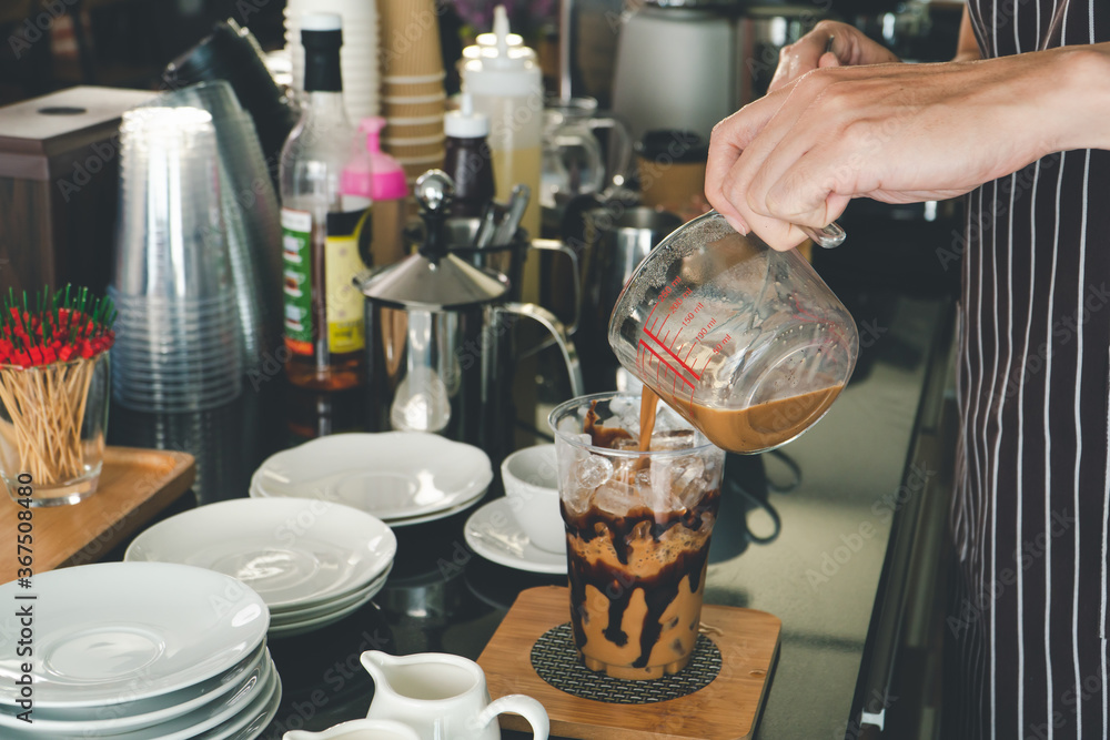 Barista is making drinks in the coffee shop. Barista is making drinks in the coffee shop.