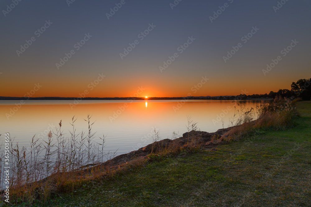 Sunset over the Lake with Clear Skies Sunset over the Lake with Clear Skies