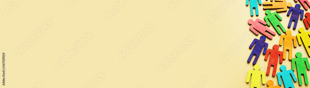 Fototapeta premium Diversity concept background. Multi-colored wooden figurines with empty space.