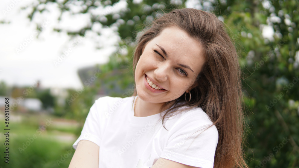 Beautiful smiling girl in white shirt in park Beautiful smiling girl in white shirt in park