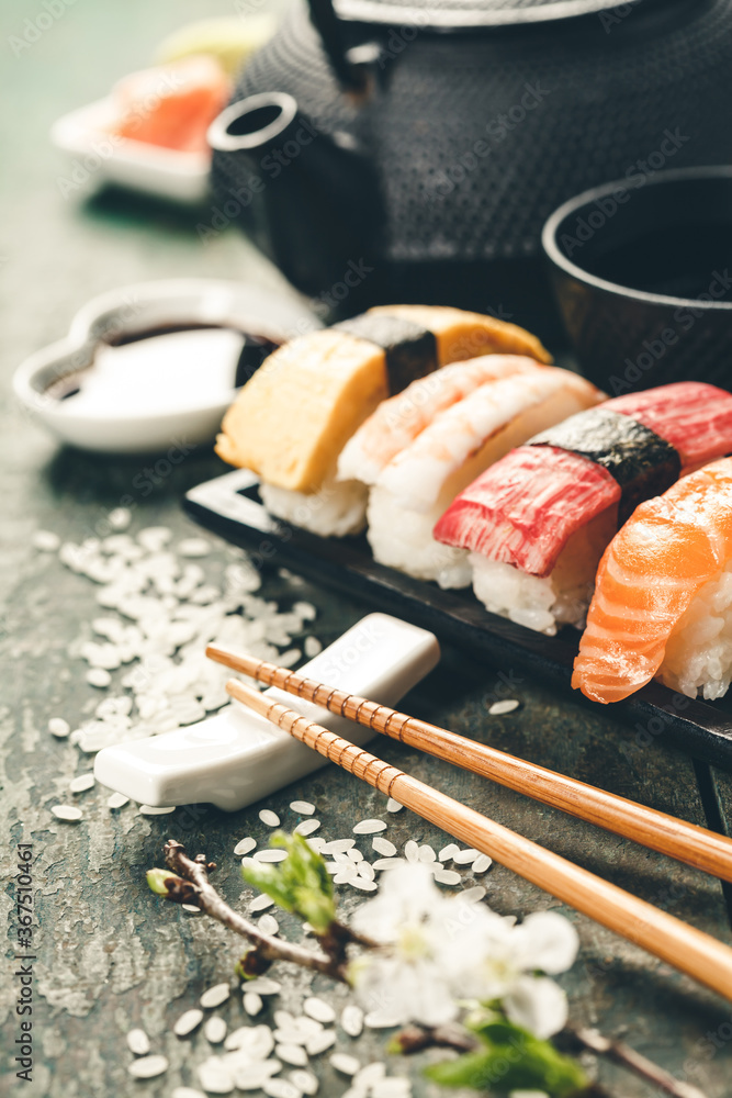 Closeup of fresh sushi on rustic wooden table - obrazy, fototapety, plakaty 