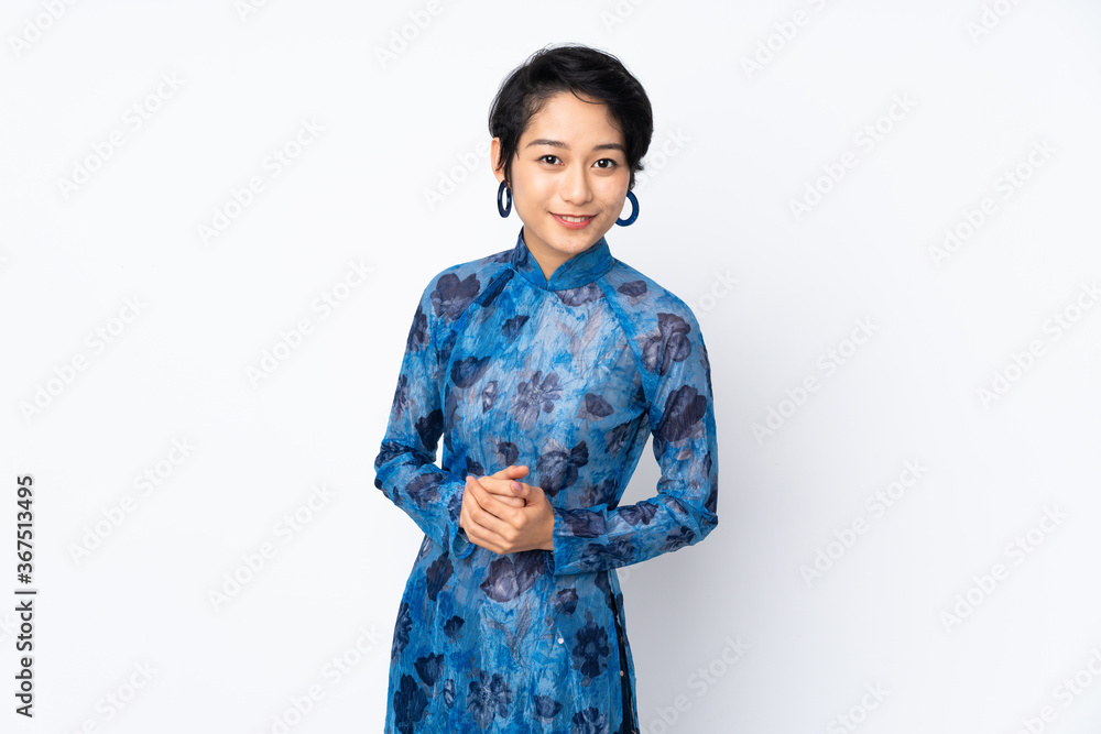 Young Vietnamese woman with short hair wearing a traditional dress over isolated white background laughing Young Vietnamese woman with short hair wearing a traditional dress over isolated white background laughing