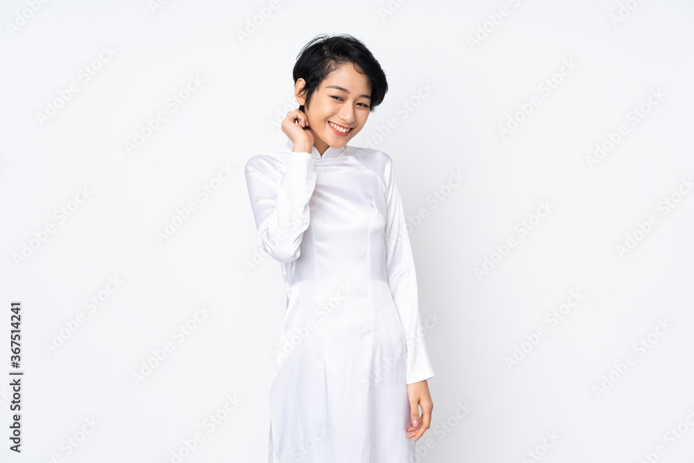 Young Vietnamese woman with short hair wearing a traditional dress over isolated white background laughing Young Vietnamese woman with short hair wearing a traditional dress over isolated white background laughing